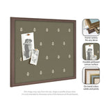 Olive green pinboard with small white botanical print, framed in medium brown wood, displaying two black-and-white photos pinned with wooden clothespins.