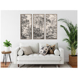 Three-panel black and white tree landscape artwork above white sofa with patterned pillows, flanked by green potted plants on each side in a neutral living room.