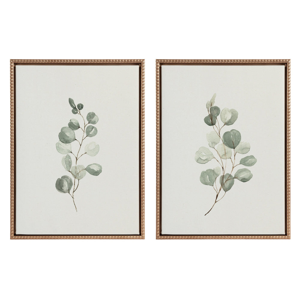 Two framed canvas eucalyptus prints with gold vintage beaded frames hung on white wall