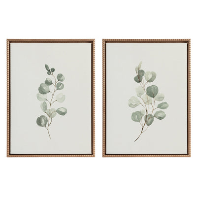 Two framed canvas eucalyptus prints with gold vintage beaded frames hung on white wall