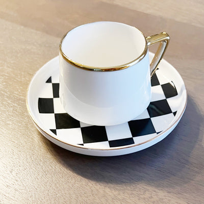 Set of six checkered espresso cups with matching saucers displaying a bold checkerboard pattern and gold rims.