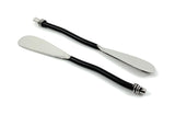 Two black-handled butter spreaders with silver flat blades, featuring decorative silver rings at the handles' ends, on a white background.