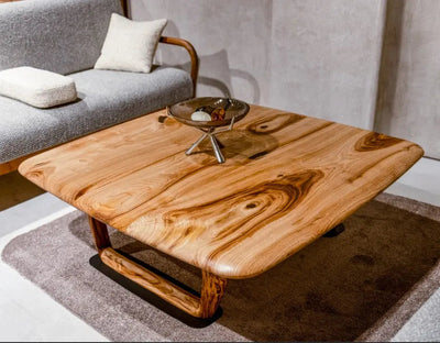 Rustic solid chestnut wood coffee table with chestnut legs in living room setting