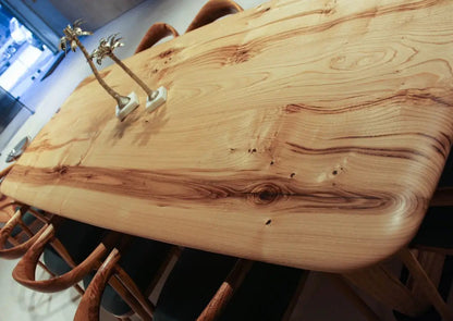 Rustic solid chestnut wood dining table with chestnut legs showing natural grain and knots