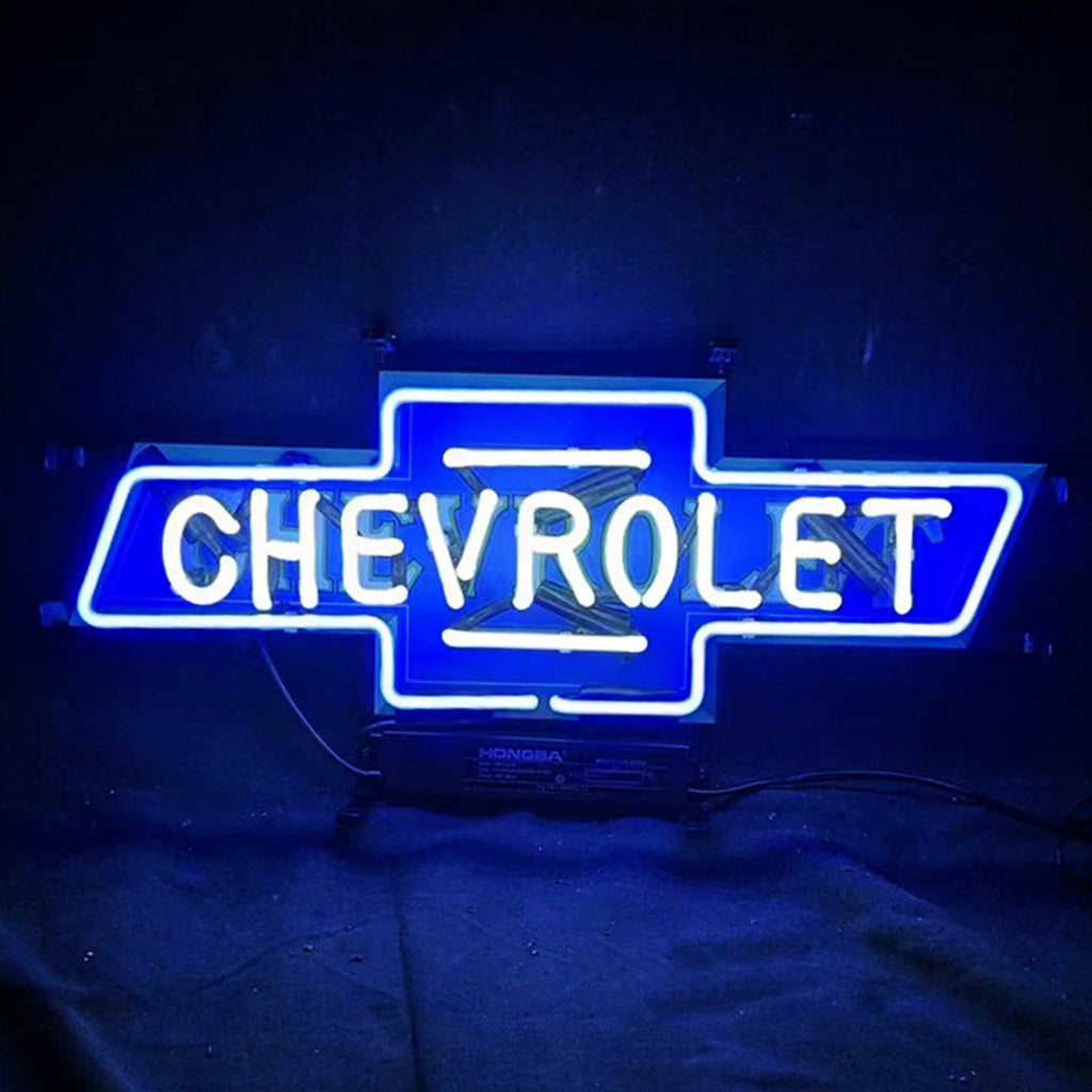 Bright blue neon sign shaped like a Chevrolet bowtie logo with 'CHEVROLET' glowing in white neon letters centered inside the blue outline on a dark background.