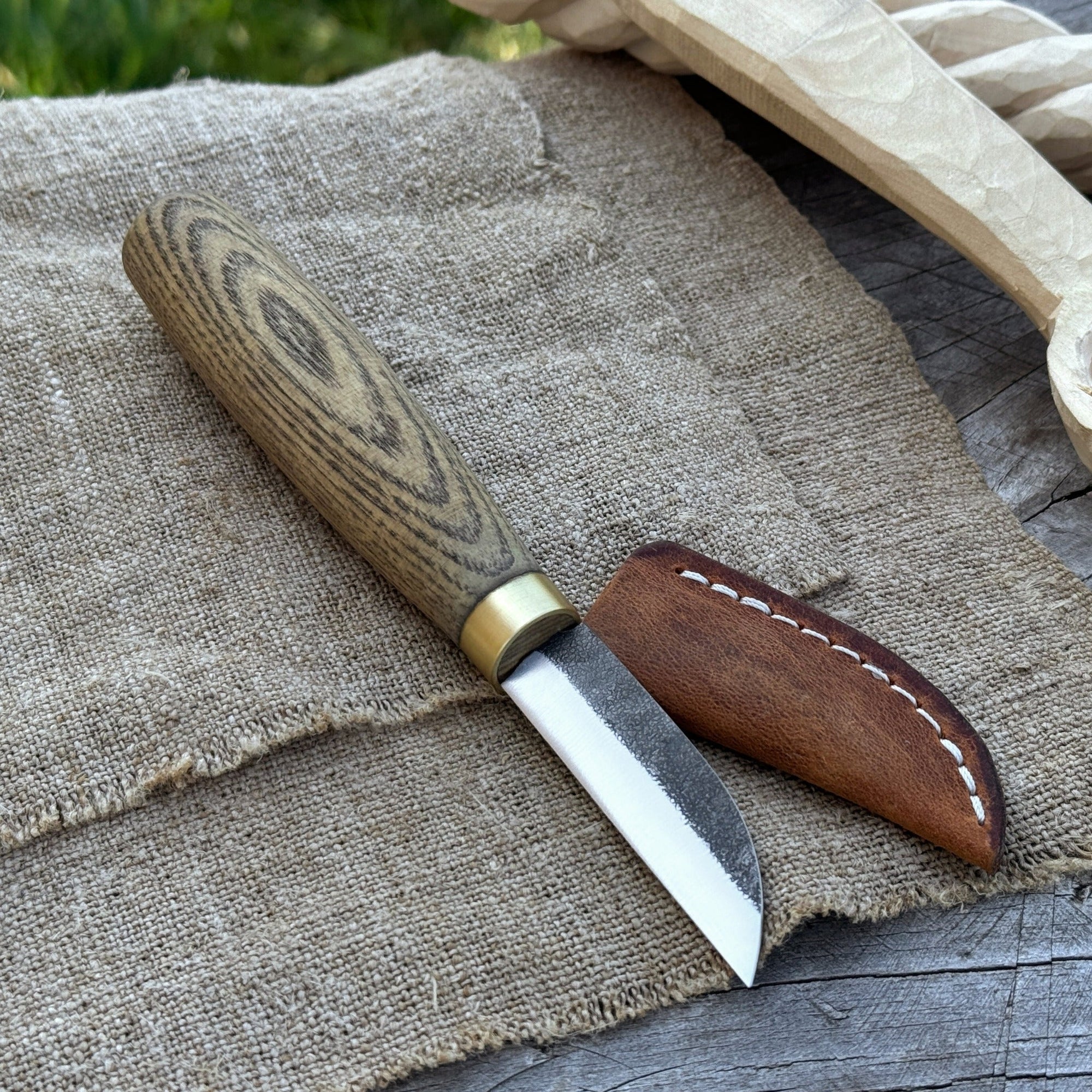 Hand-forged chip carving knife with ash wood handle and leather sheath