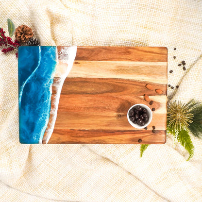 acacia resin serving bread board with blue resin design on a textured surface