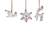 Metallic silver Christmas ornaments shaped as a sleigh, snowflake, and reindeer, each accented with small red dots and hanging from red strings.
