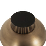 Close-up of a round metallic knob with vertical ribbed texture and a matte black circular top, set on a brushed bronze surface.