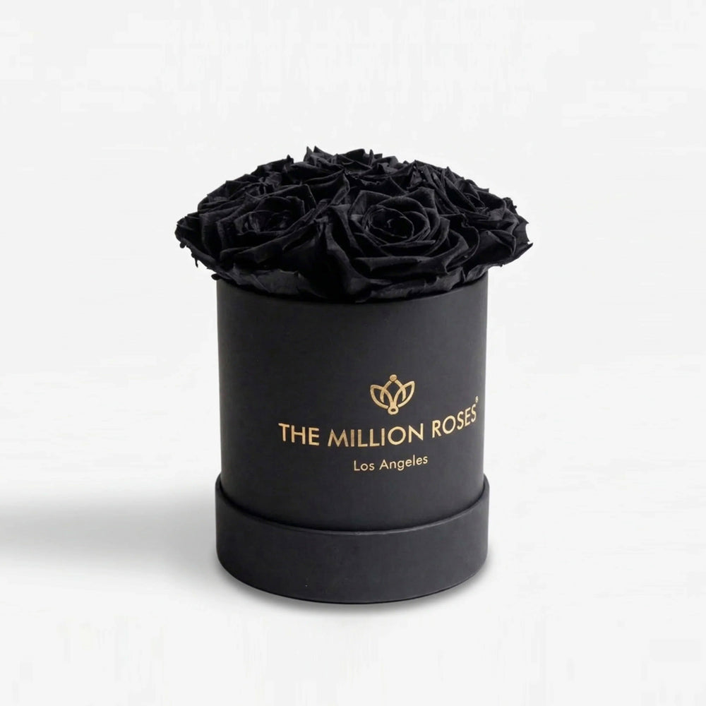 Essence Black Box containing seven black roses arranged in a square black box