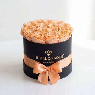 Black box containing 14-15 peach roses arranged neatly