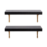 Two rectangular black wood floating shelves with smooth surfaces, each supported by two gold-colored metal brackets underneath, against a white background.