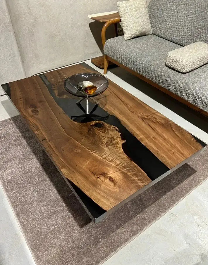Handcrafted resin coffee table with smoke-colored resin river and solid walnut legs