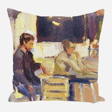 Painterly image on a pillow depicting two seated figures in muted tones of purple, yellow, and beige, suggesting a casual indoor scene with expressive brushstrokes.