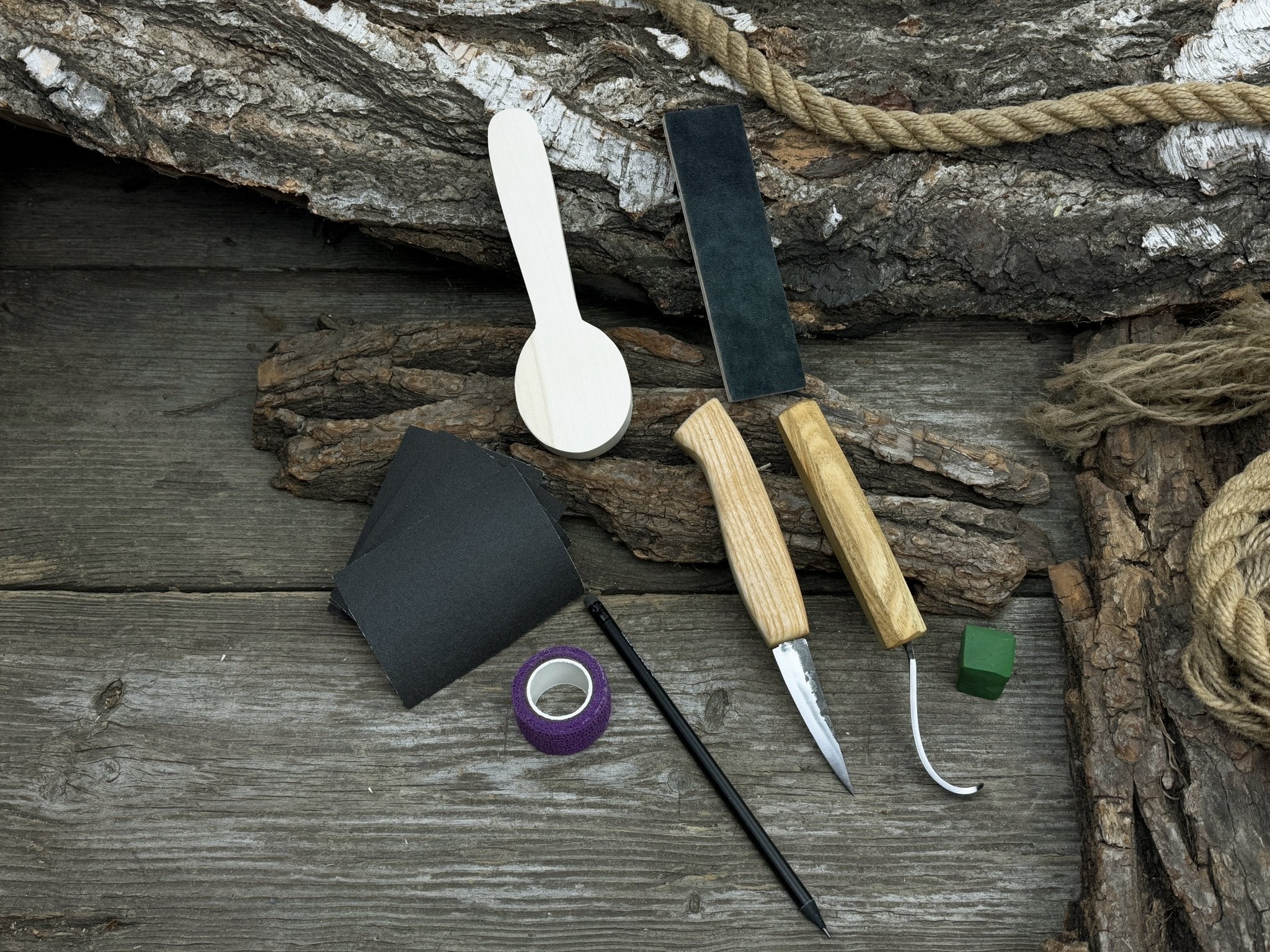 Complete Spoon Carving Kit for Beginners with knives, wooden blank, sandpaper, and sharpening board
