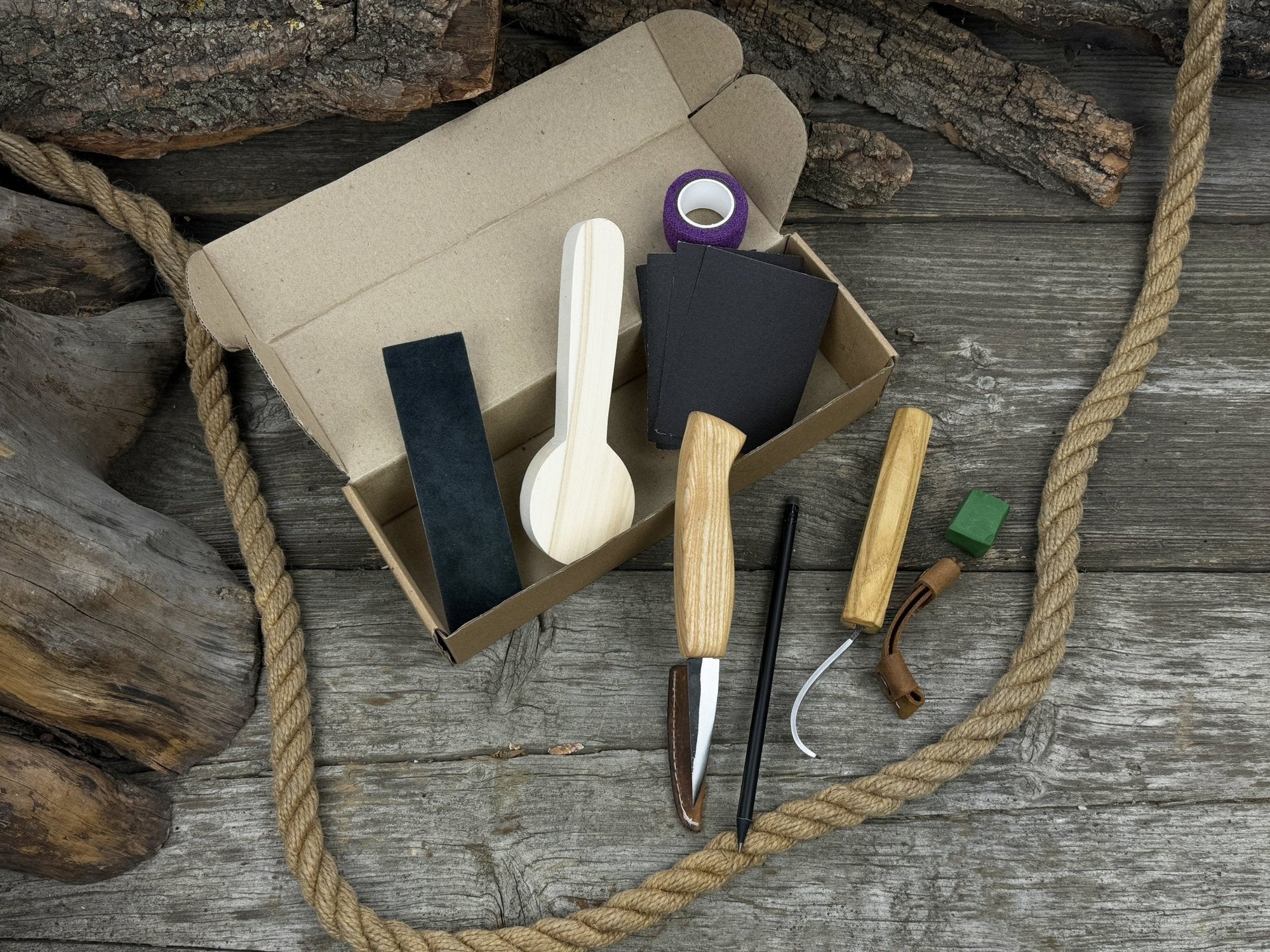 Complete Spoon Carving Kit for Beginners with knives, wooden blank, sandpaper, and sharpening board