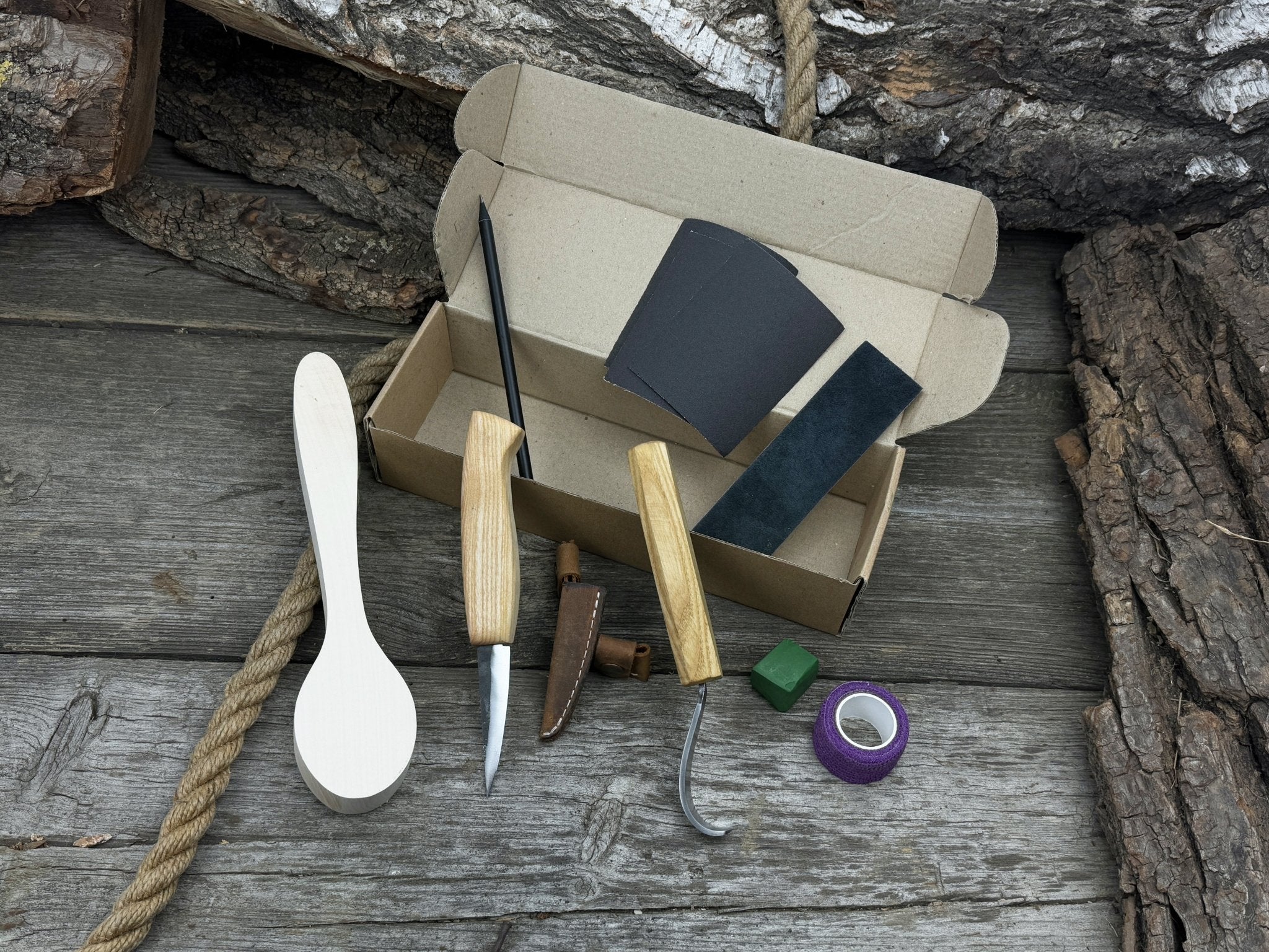 All-in-one wooden spoon whittling kit with knives, wooden blank, sandpaper, and sharpening tools
