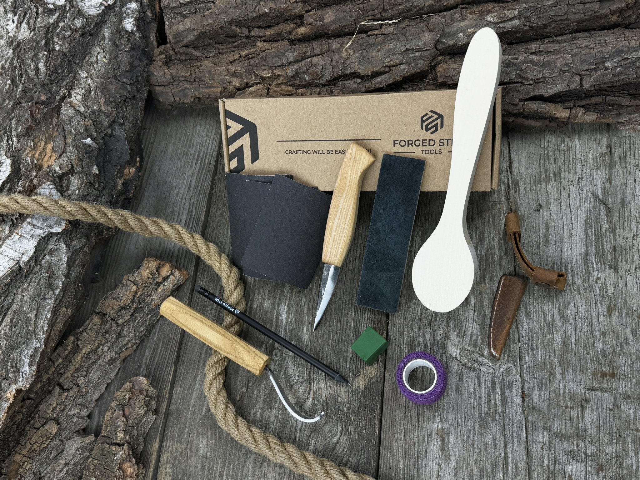 All-in-one wooden spoon whittling kit with knives, wooden blank, sandpaper, and sharpening tools