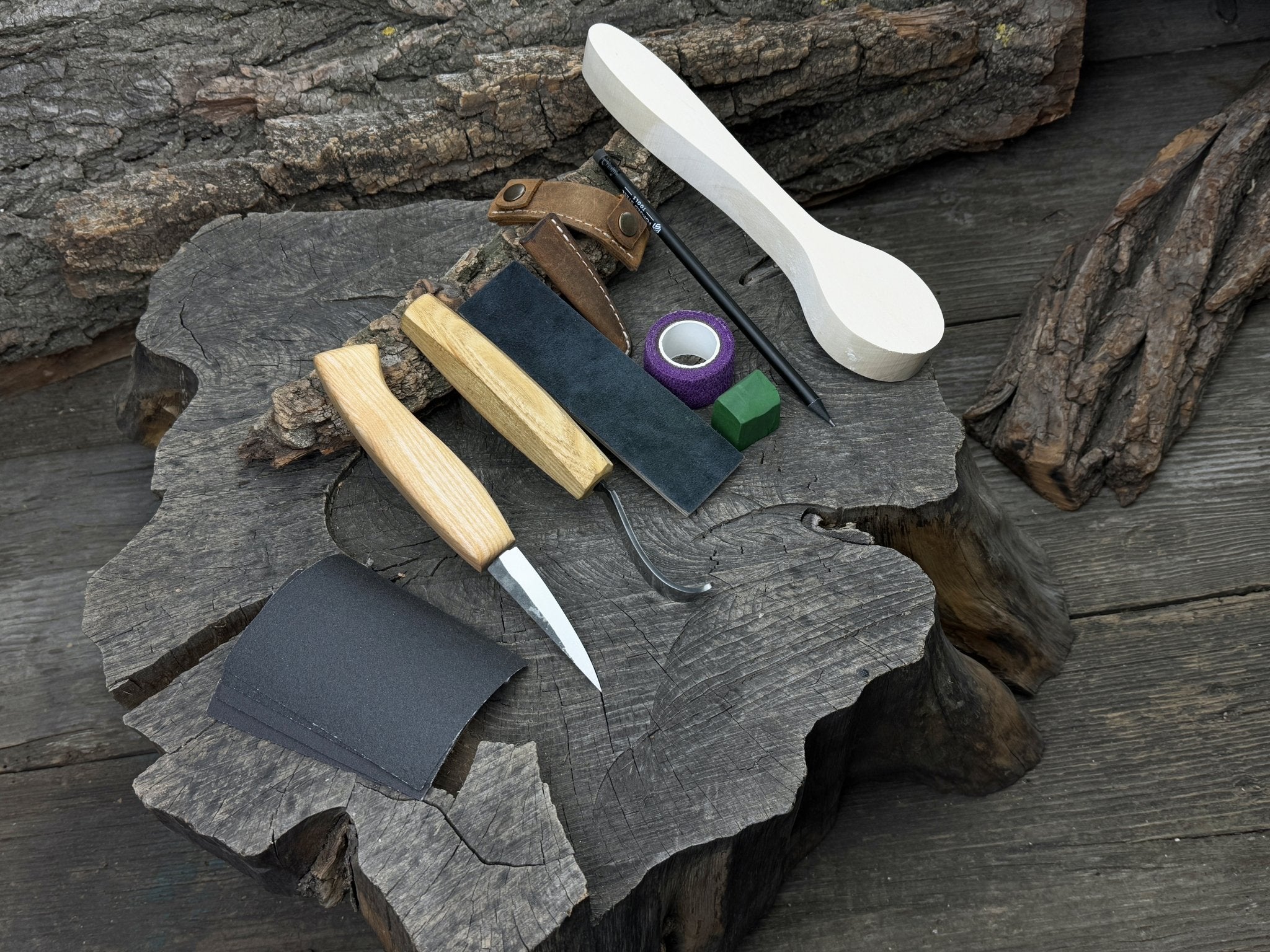 All-in-one wooden spoon whittling kit with knives, wooden blank, sandpaper, and sharpening tools