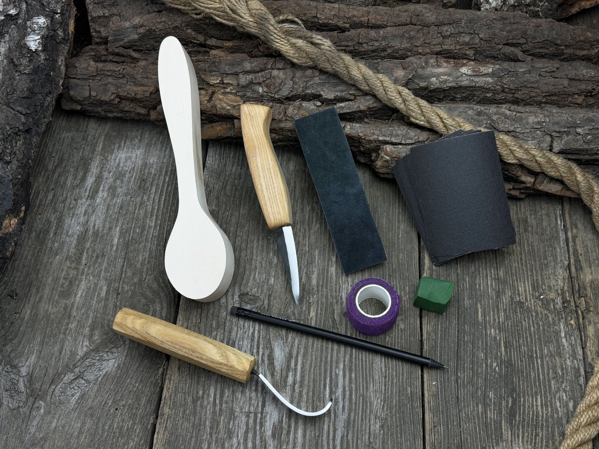 All-in-one wooden spoon whittling kit with knives, wooden blank, sandpaper, and sharpening tools
