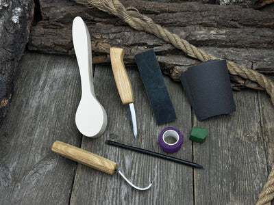 All-in-one wooden spoon whittling kit with knives, wooden blank, sandpaper, and sharpening tools