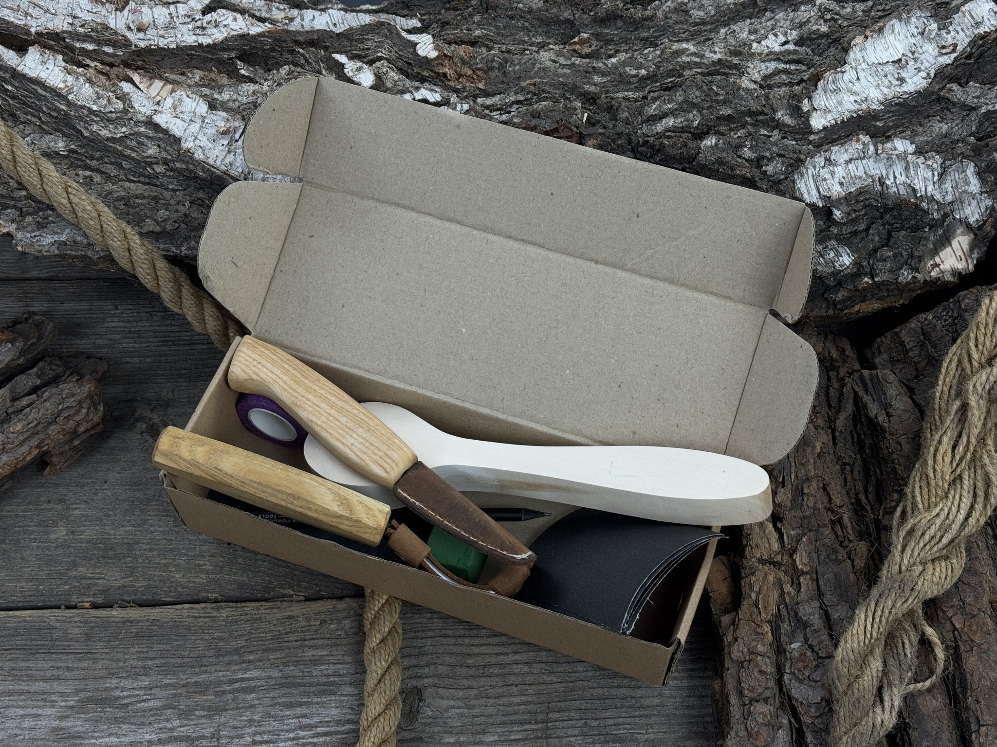 All-in-one wooden spoon whittling kit with knives, wooden blank, sandpaper, and sharpening tools