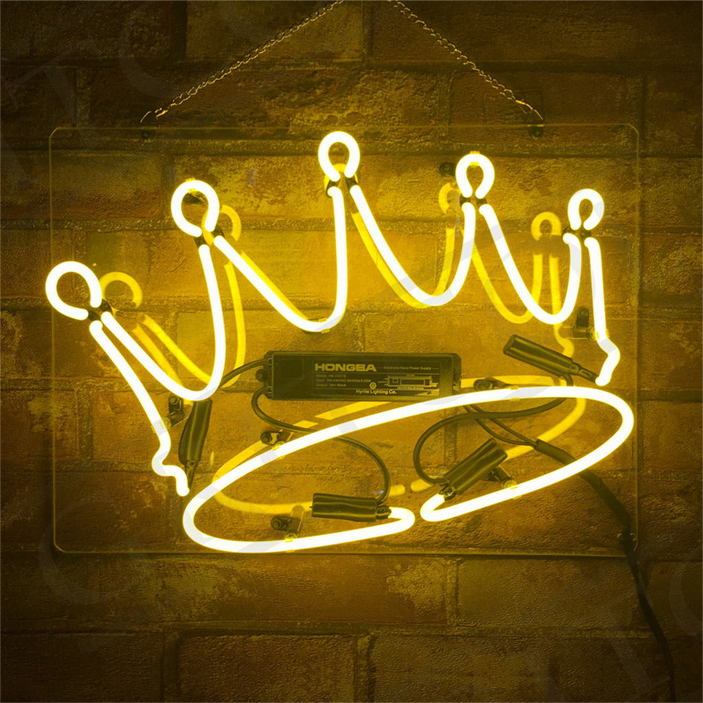 Crown-shaped yellow neon sign illuminated and hanging indoors