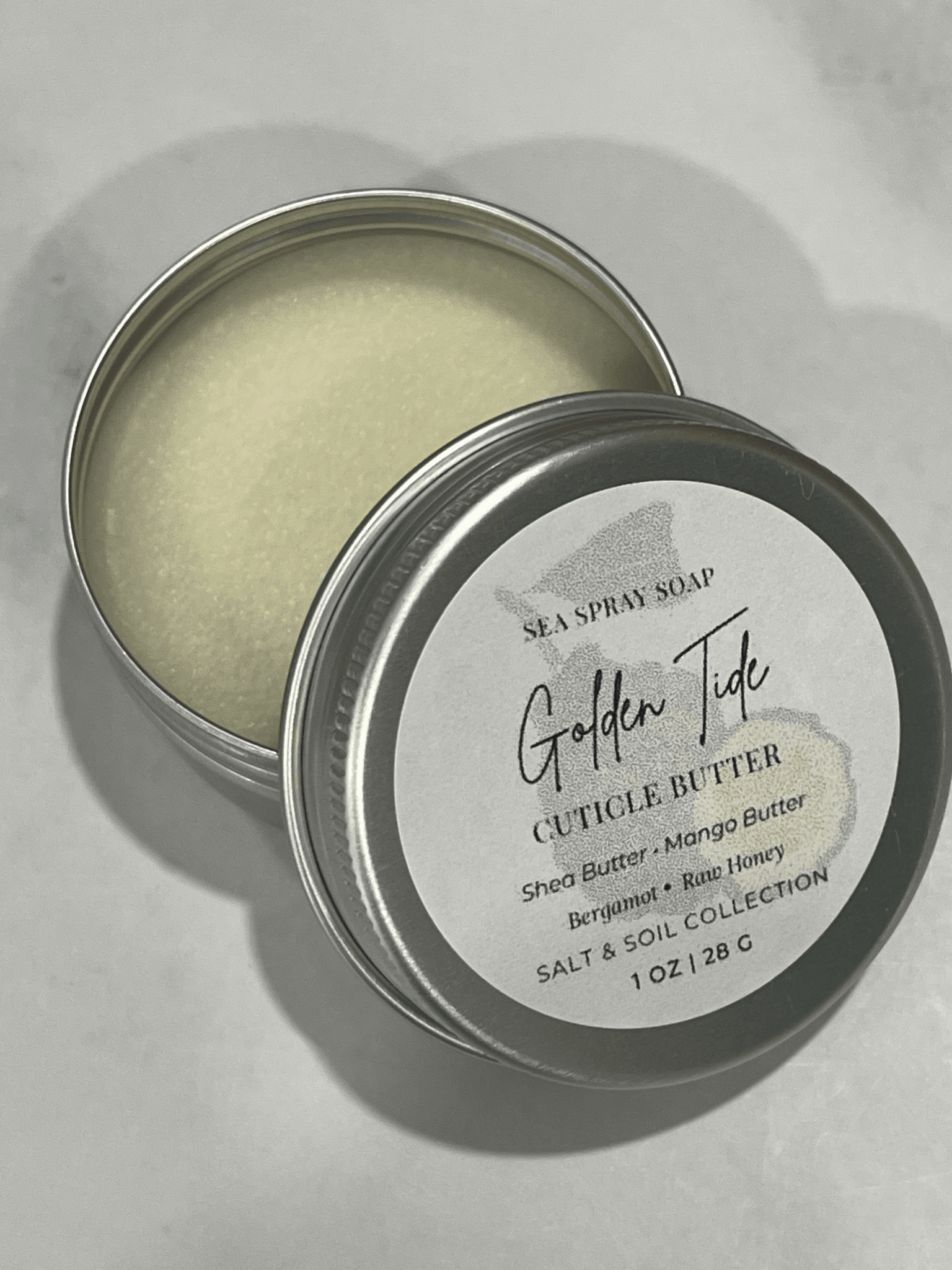 Golden Tide Cuticle Butter tin with soft cream texture and white label