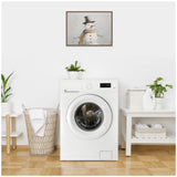 Framed snowy white beaded snowman portrait with a brown hat and twig arms, hanging on a white wall above a white front-loading washing machine in a bright laundry room.