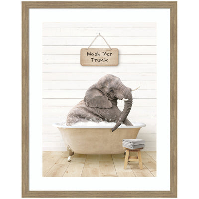Framed wall art print of a young elephant sitting in a modern bathtub, surrounded by green tiled walls and bath accessories.
