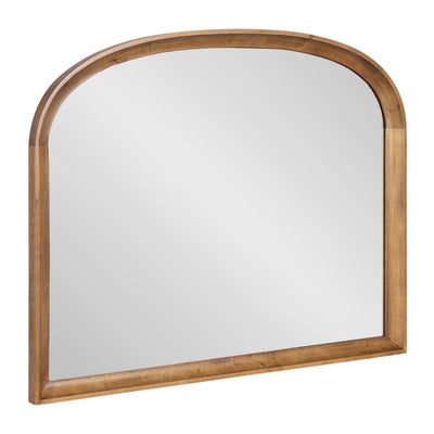 Hatherleigh Basket Arch Wall Mirror with gold wooden frame leaning against a textured neutral wall
