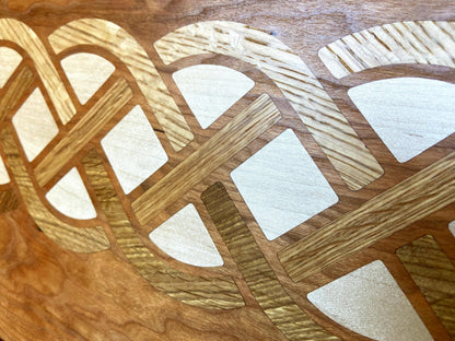 Cherry wood charcuterie board with white oak and maple Celtic knot inlay by Fitzgerald Custom Woodcraft