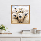 Framed photograph on a white wall showing a close-up of nine curious polar bears clustered together in snowy terrain under a partly cloudy sky.