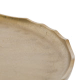 Close-up of a beige, round surface with a slightly scalloped edge and subtle textural variations, likely part of the Alessia Round Coffee Table.