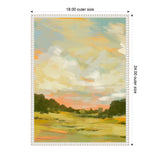 Framed canvas painting depicting a landscape with a soft orange and blue sky above green and yellow fields bordered by dark green trees.