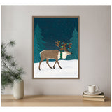 Framed canvas showing a brown reindeer with decorated antlers and green scarf walking on snow under a starry night sky between two pine trees.
