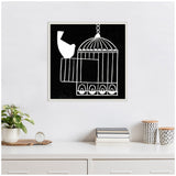 Black and white linocut artwork showing a bird perched on the open door of a hanging cage with a white frame on a light wall above a shelf with books and plants.