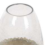 Close-up of a clear, hammered glass cloche with an open top and smooth rounded edges, showcasing textured reflections on its surface.