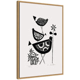 Black linocut illustration of three stylized birds with patterned bodies, perched among simple floral shapes on white background, framed in natural wood.