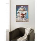 Framed canvas wall art showing a blonde woman with a large white moth covering her eyes, a crown of moon phases above her head, set against a starry blue background.