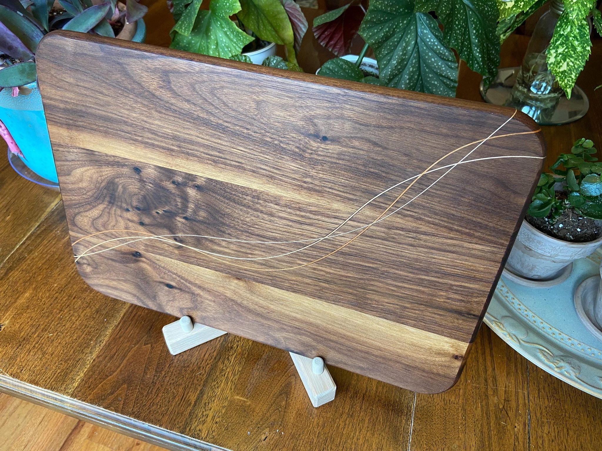 Walnut charcuterie board with Cherry and Maple decorative banding, handcrafted by Fitzgerald Custom Woodcraft