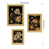 Three framed floral prints with gold ornate frames on a black background featuring pink and beige flowers and green leaves, arranged in an asymmetrical layout.