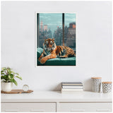 Framed canvas of a tiger lounging on a teal sofa with a New York City skyline visible through large windows behind it, hung on a white wall above a white dresser.
