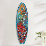 Vertical surfboard-shaped wall art featuring colorful coral, seashells, and tropical fish in vibrant blue, red, and orange underwater scene.