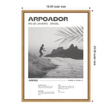Black and white framed photo of a surfer riding waves with distant mountains and palm leaves in Rio de Janeiro, labeled 'Arpoador' with coordinates and surf details.