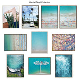 Grid of ten framed artworks including aerial beach scenes with turquoise water, palm trees by a road with a van, an abstract cactus, and colorful umbrellas on sand.