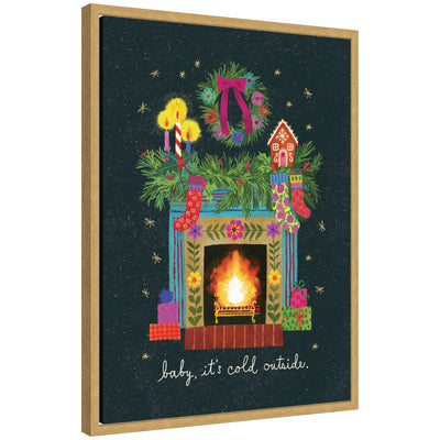 Sylvie framed canvas art depicting a Christmas fireplace decorated with stockings, a wreath, candles, and a gingerbread house on the mantle surrounded by wrapped gifts.