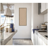 Bright kitchen with beige lattice patterned artwork framed on the white wall, featuring concrete countertops and modern white cabinetry under natural light.