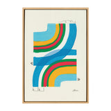 Abstract framed canvas with overlapping curved bands in blue, yellow, red, and green on a white background, signed by Amber Vittoria in lower right corner.