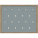 Rectangular pinboard covered in muted blue fabric with evenly spaced small white botanical block print motifs, framed in light natural wood.
